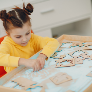 Girl playing with puzzles.