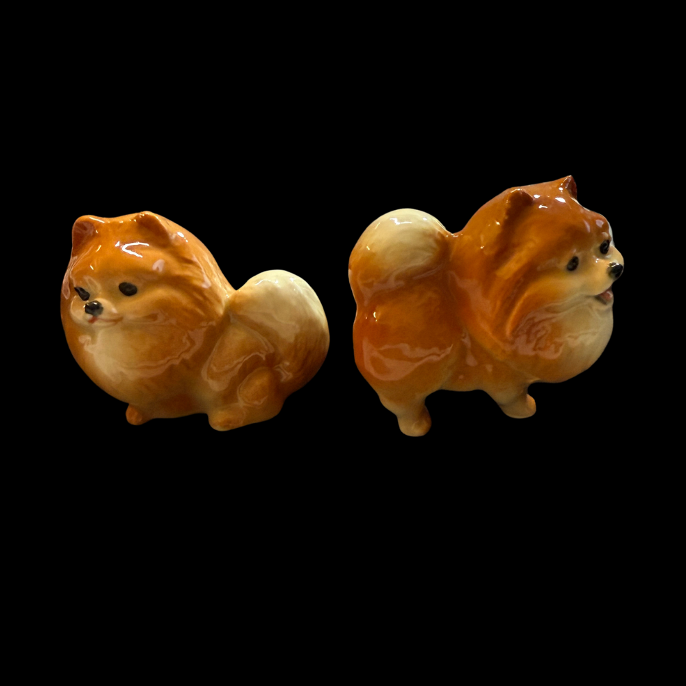 TMT Imports ceramic Pomeranian dog figurines in seated and standing designs