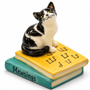 Image ALT Text: TMT Imports black and white cat ceramic figurine sitting on books