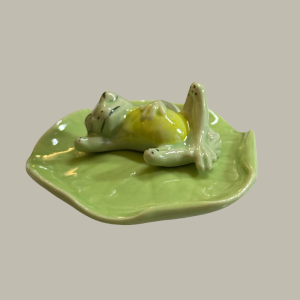 TMT Imports ceramic frog lying on green lily pad ornament